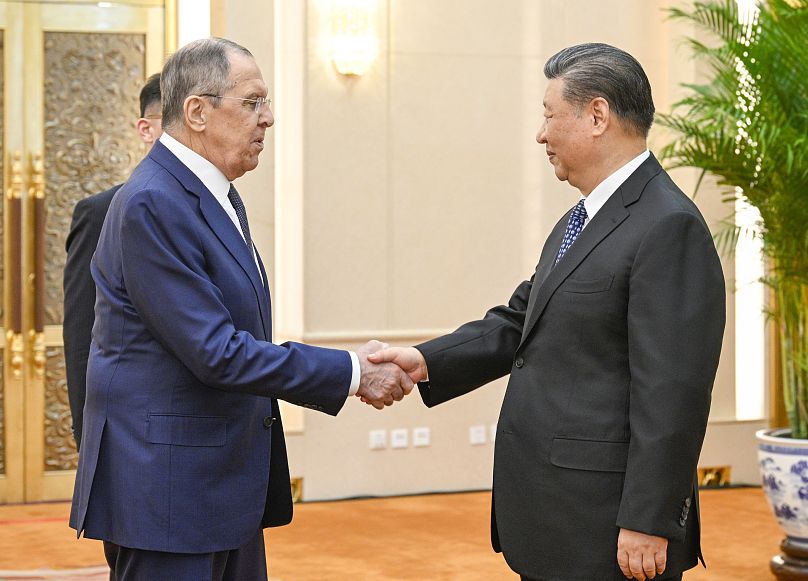 Russian Foreign Minister Sergey Lavrov, left, and Chinese President Xi Jinping meets at the Great Hall of the People in Beijing on April 9, 2024.