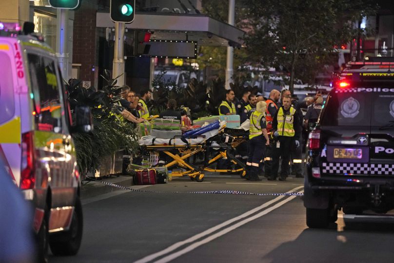 Emergency officers stand by with stretchers outside Westfield Shopping Centre where multiple people were stabbed in Sydney, Saturday, April 13, 2024.