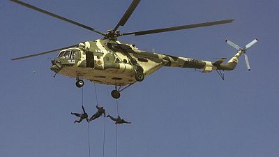 FILE - Iranian police special forces rappel down from their helicopter during an exercise commemorating "Police Week", in downtown Tehran, Iran, Friday, Oct. 7, 2011