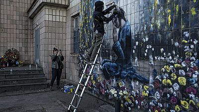 Artists from California painting a mural in the Ukrainian town of Bucha