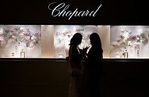 Two women stand in front of Chopard's booth at Watches and Wonders Geneva 2024.