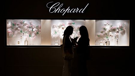 Two women stand in front of Chopard's booth at Watches and Wonders Geneva 2024.