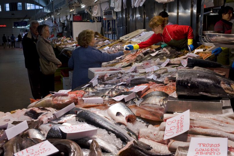 A woman pays at a fish stall in Pamplona, May 2012