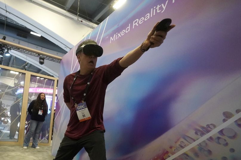A man plays the Mixed Reality Fencing Prototype game while visiting the Meta booth at the Game Developers Conference 2023 in San Francisco, March 2023