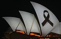 Sydney Opera House is illuminated with a black ribbon Monday, April 15, 2024, as part of the national day of mourning following stabbing deaths of several people at a shop