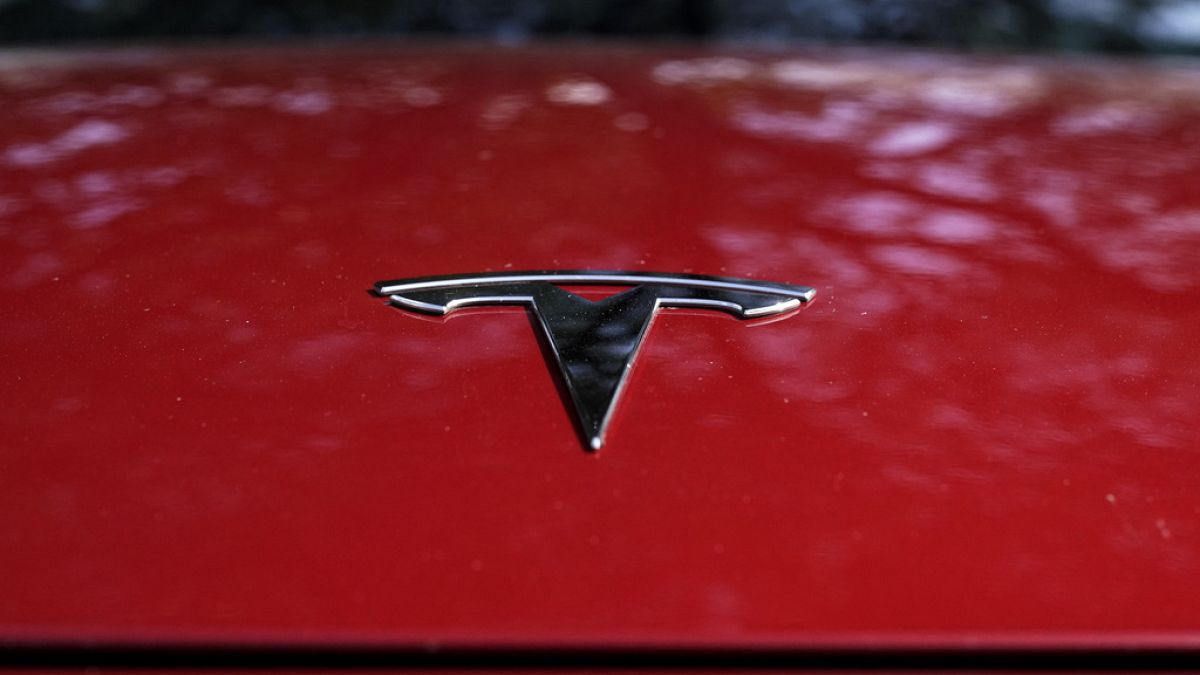 A Tesla logo is seen on a vehicle on display in Austin, Texas, Feb. 22, 2023. 