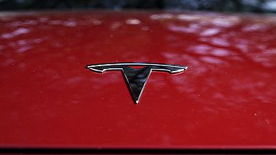 A Tesla logo is seen on a vehicle on display in Austin, Texas, Feb. 22, 2023. 
