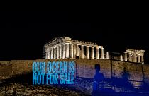 Greenpeace Greece activists project a message reading: 'Our Ocean Is Not For Sale' onto the Acropolis Hill.