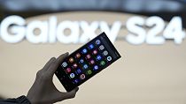 An employee holds the Samsung Electronics' new smartphone Galaxy S24 Ultra for a photograph at a shopping mall in Seoul, South Korea, Thursday, Jan. 18, 2024. 