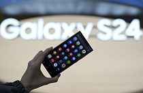 An employee holds the Samsung Electronics' new smartphone Galaxy S24 Ultra for a photograph at a shopping mall in Seoul, South Korea, Thursday, Jan. 18, 2024. 