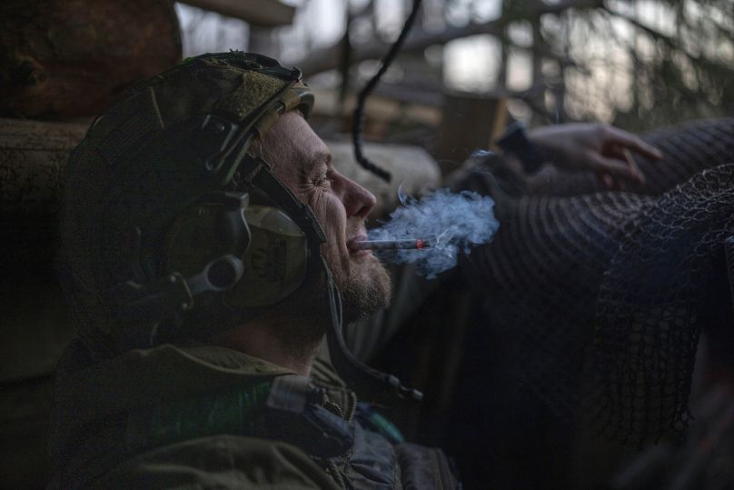 A Ukrainian serviceman smokes a cigarette.