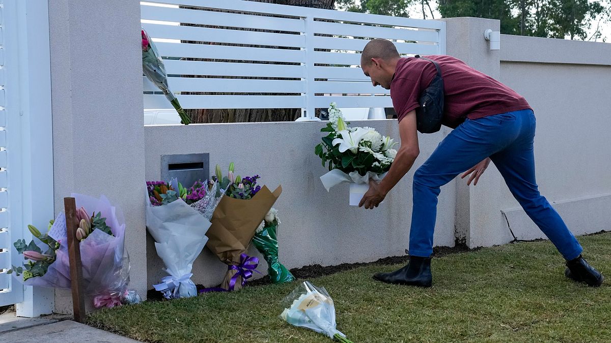 A man places flowers outside the Christ the Good Shepherd church in suburban Wakely in western Sydney, Australia, Tuesday, April 16, 2024. 