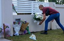 A man places flowers outside the Christ the Good Shepherd church in suburban Wakely in western Sydney, Australia, Tuesday, April 16, 2024. 