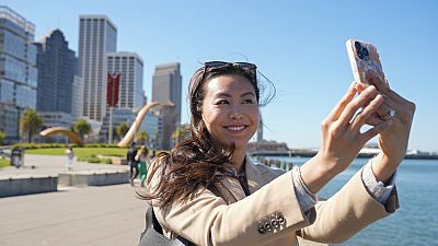 Contented content creator Cynthia Huang Wang works along the Embarcadero in San Francisco, Monday, April 8, 2024. 