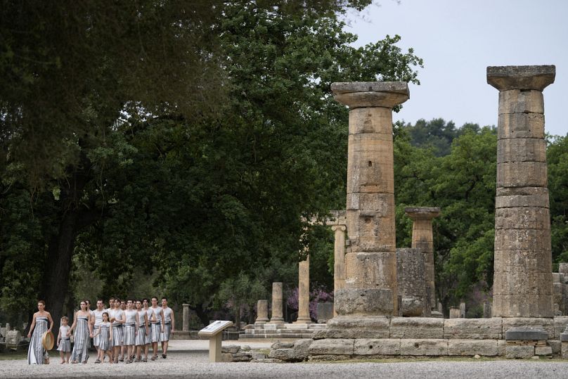 Performers take part in the official ceremony of the flame lighting for the Paris Olympics.