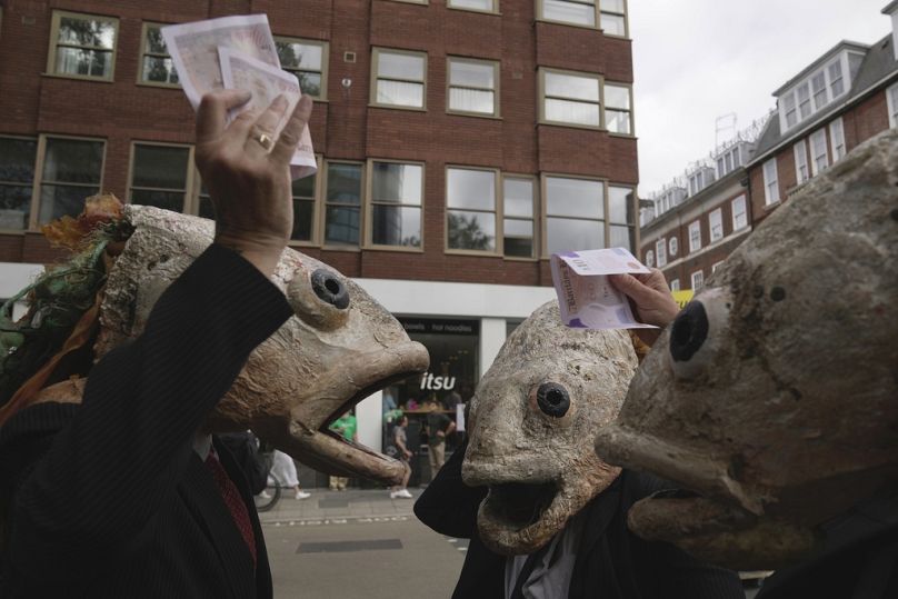 Demonstrators wear fish masks as they protest outside the Department for Environment Food & Rural Affairs (DEFRA) about overfishing, in London, September 2023
