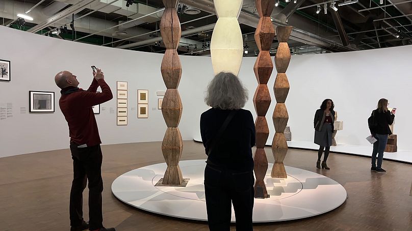 Visitors look at Constantin Brancusi's columns at the exhibition in Centre Pompidou.