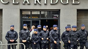 Police stand guard outside the front entrance of the event venue as the National Conservatism conference takes place in Brussels, Tuesday, April 16, 2024. 