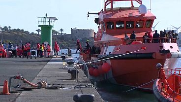 Migrants disembark a coastguard ship in Lanzarote