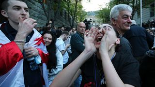 Ein Demonstrant schreit vor dem Parlamentsgebäude in Tiflis, Georgien, am Dienstag, 16. April 2024