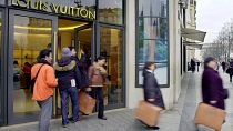 Shoppers leave the Champs Elysees Louis Vuitton shop in Paris 
