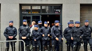 Police stand guard outside the front entrance of the event venue as the National Conservatism conference takes place in Brussels, Tuesday, April 16, 2024.