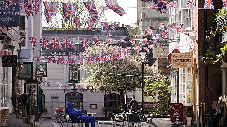 Union Jack flags are decorated in a street in Windsor, England, Saturday, March 23, 2024. 