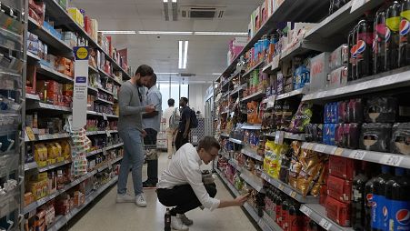 Shoppers buy food in a supermarket in London (file photo)