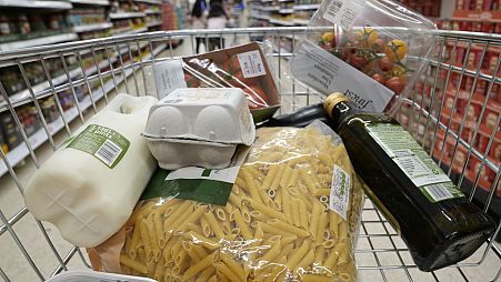 Shoppers buy food in a supermarket in London (file photo)