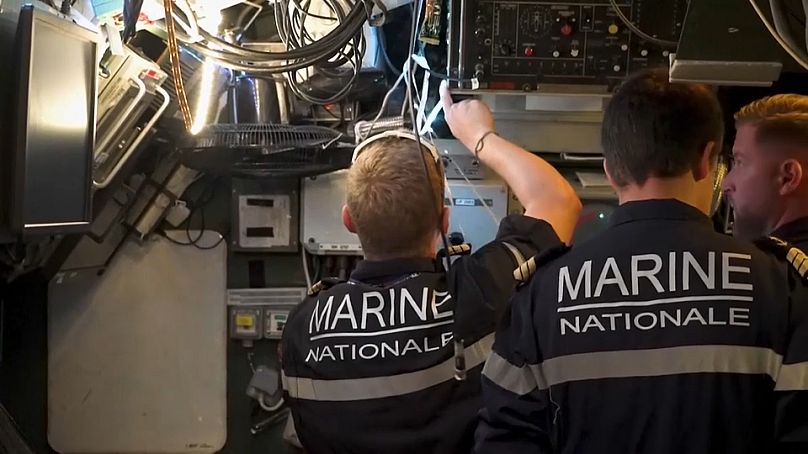 Crew members working aboard one of France's Rubis-class military submarines