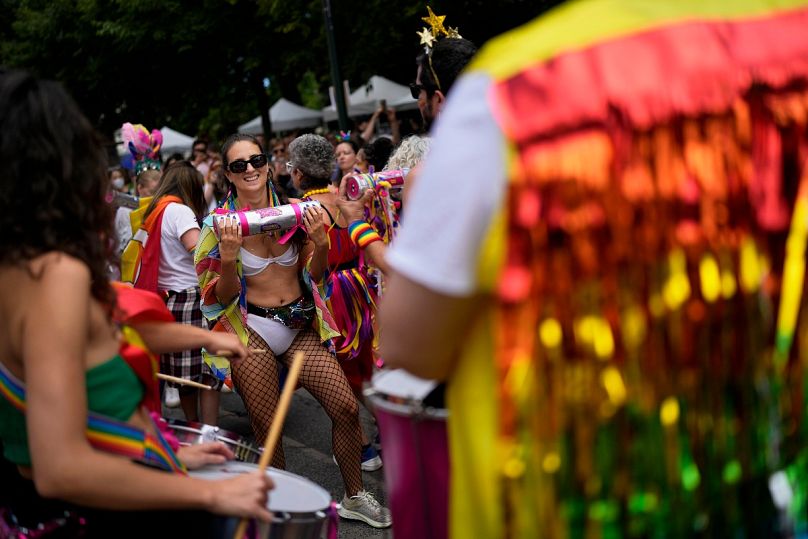 Revelers dance while taking part in Lisbon's Gay Pride parade in 2022