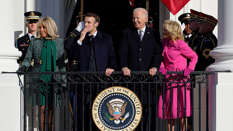 Emmanuel Macron blows a kiss as he stands alongside his wife Brigitte Macron, President Joe Biden and first lady Jill Biden
