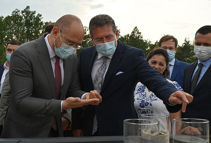 Ukraine's prime minister Denys Shmyhal and European Commission vice-president Maroš Šefčovič examine a titanium sample in Zhytomir, July 2021