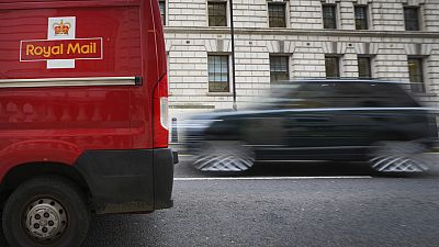 A car overtakes a Royal Mail delivery van, in Westminster in London, Thursday, Jan. 25, 2024.