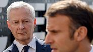 President Emmanuel Macron addresses the media as France's Minister for Economy and Finances Bruno Le Maire, looks on