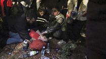 People help an unconscious demonstrator during a rally outside the parliament building in Tbilisi, Georgia, on Thursday, April 18, 2024, 