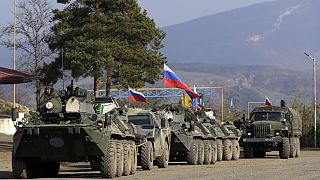 Russian peacekeepers' vehicles are parked at a checkpoint on the road to Shusha in the separatist region of Nagorno-Karabakh, on Tuesday, Nov. 17, 2020