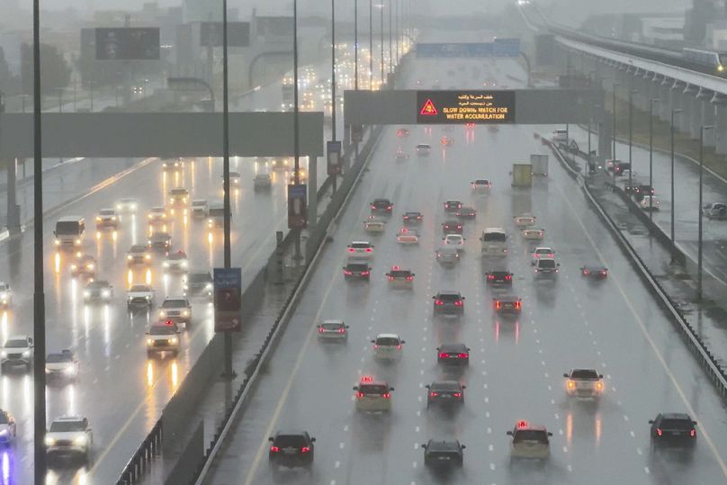 Vehicles drive through heavy rain on the Sheikh Zayed Road highway in Dubai, United Arab Emirates.