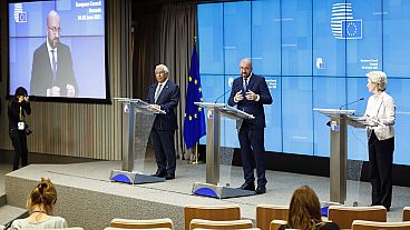 European Council President Charles Michel, centre, speaks with Commission President Ursula von der Leyen, right, and Portugal's Prime Minister Antonio Costa. June 25, 2021.