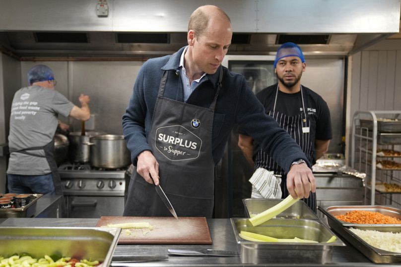 Britain's Prince William cuts celery as he helps to make a bolognase sauce during a visit to Surplus to Supper, in Sunbury-on-Thames, Surrey, England, Thursday, April 18, 2024