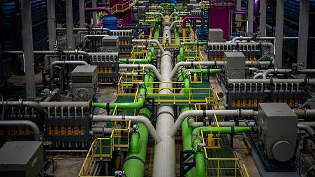 A worker walks over the pipeline that transports seawater to filters at Europe's largest desalination plant for drinking water located in Barcelona.