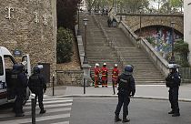 Police officers and rescue worker wait for instructions bar the the Iranian consulate, Friday, April 19, 2024 a in Paris