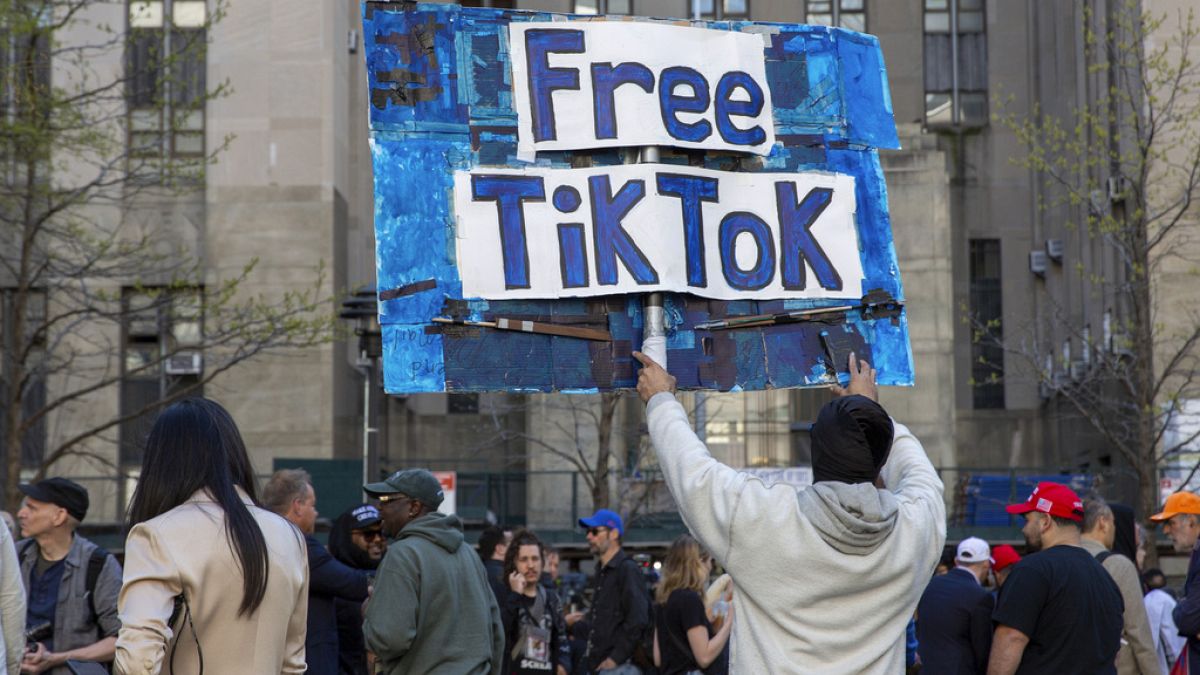 A man carries a Free TikTok sign in front of the courthouse where the hush-money trial of Donald Trump got underway April 15, 2024, in New York.