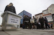 Kosovo election officials carry the ballot boxes and polling station materials in North Mitrovica, Kosovo 