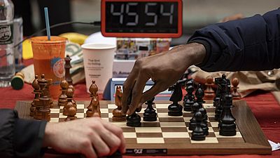 Tunde Onakoya, 29, a Nigerian chess champion and child education advocate, plays a chess game in Times Square