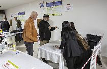 A voter is identified before he casts his vote at a polling station in North Mitrovica, Kosovo Sunday, April 21, 2024.