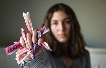Sarina Horner, a 17-year-old senior at Forsyth Country Day School, holds a fistful of tampons as she sits for a portrait on her bed on Monday, Feb. 14, 2022, in Lewisville NC.