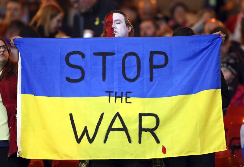 A Polish football fan shows his support to Ukraine during the International friendly match between Scotland and Poland in Glasgow, March 2022