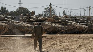 جندي إسرائيلي بالقرب من مجموعة من الدبابات الإسرائيلي بالقرب من قطاع غزة
