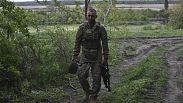 A Ukrainian serviceman with the 65th Brigade walks to his armored vehicle at the frontline in Zaporizhzhia region, Ukraine, Sunday, April 21, 2024. 